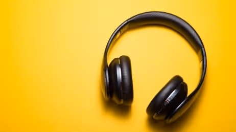 Black headphones on a bright yellow background