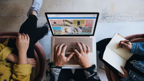 Person working on laptop while collaborating