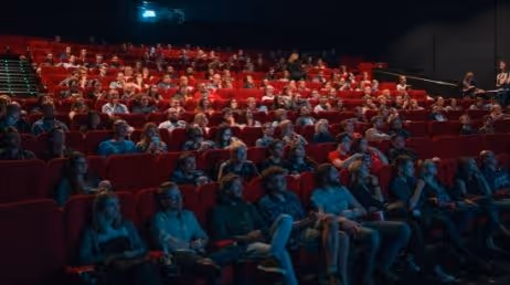 Audience seated in a theater for a presentation