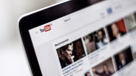 YouTube video recommendations on a laptop screen
