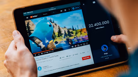 YouTube video playing on a tablet screen with gaming content