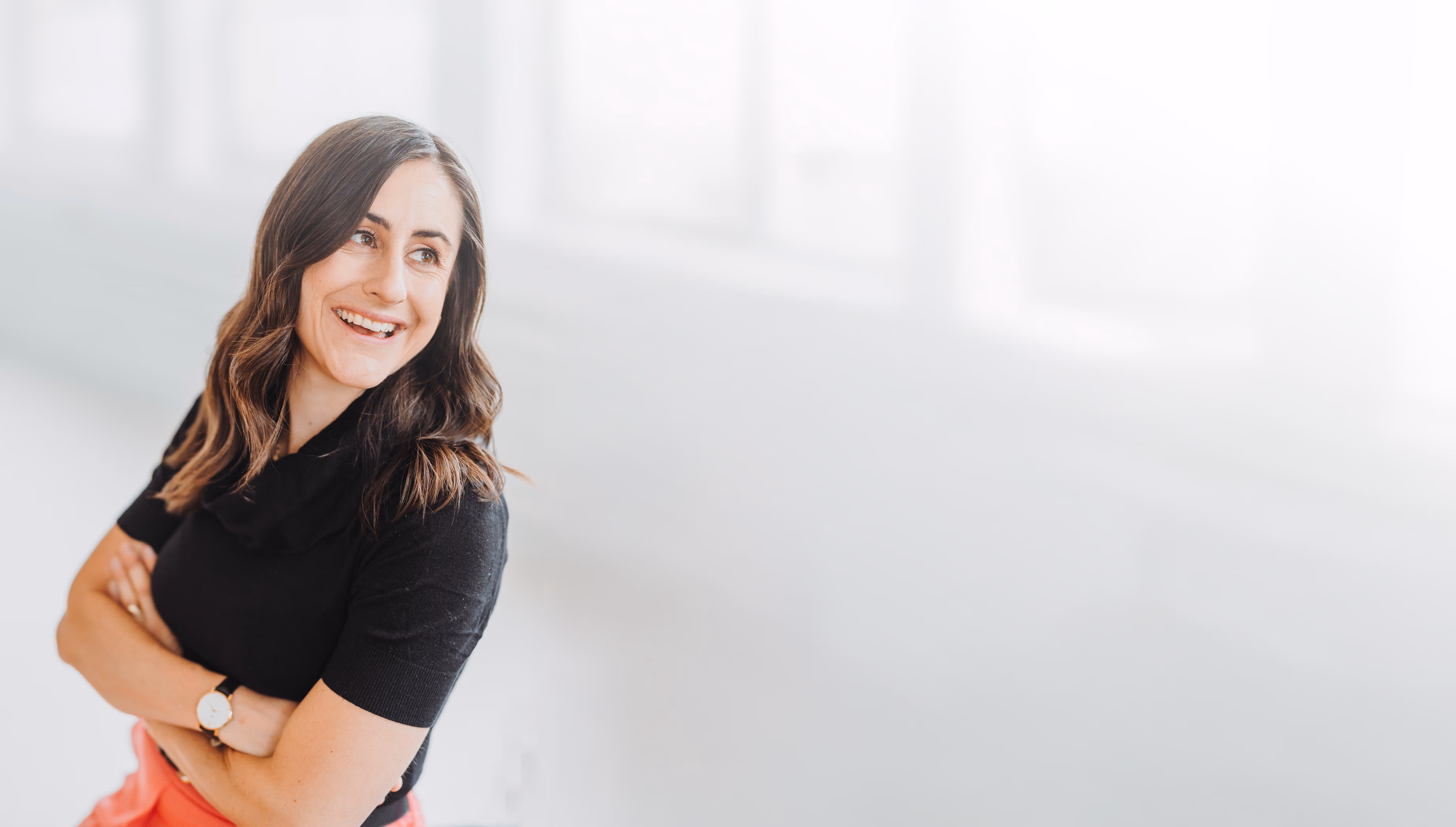 Sandra Wettstein KMU Beraterin lächelnd nach rechts schaut und die Arme verschränkt hat.