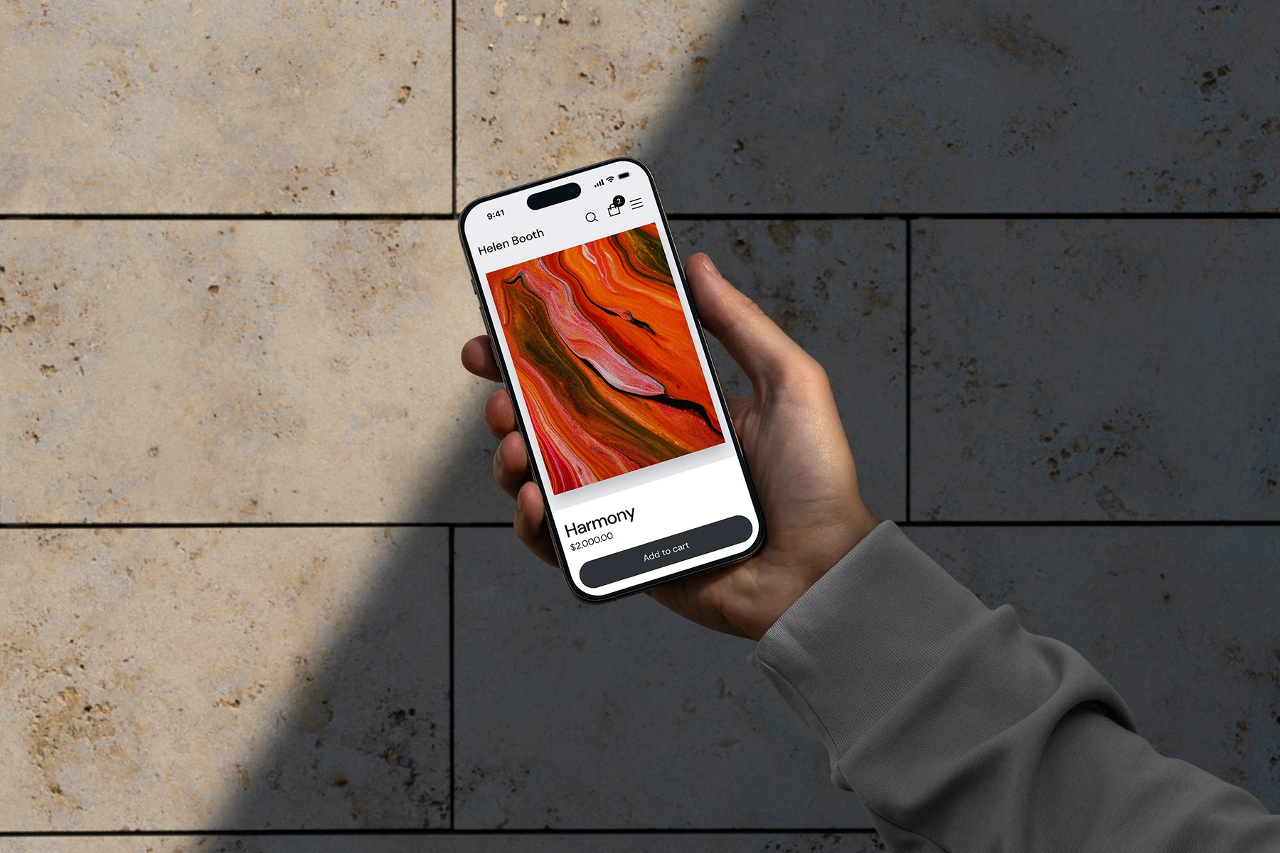 Hand holding a smartphone displaying an online store page with an abstract artwork titled 'Harmony' priced at $2,000, with an 'Add to cart' button.