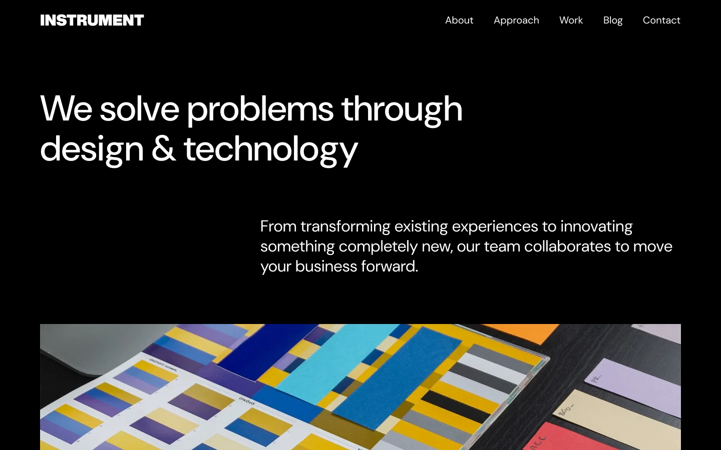 Website header with text 'We solve problems through design & technology' and a color swatch palette on a table below.