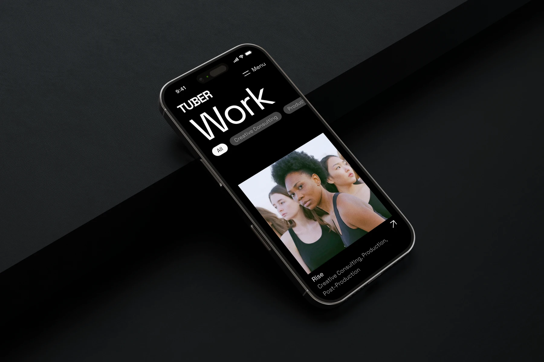 Smartphone displaying a black interface titled 'TUBER Work' with a photo of three women looking forward, labeled 'Rise, Creative Consulting, Production, Post-Production.'