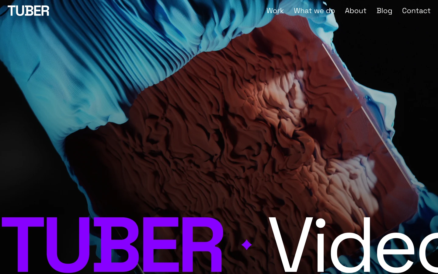 Blue-gloved hands holding a glass panel above a textured, reddish surface resembling sculpted clay.