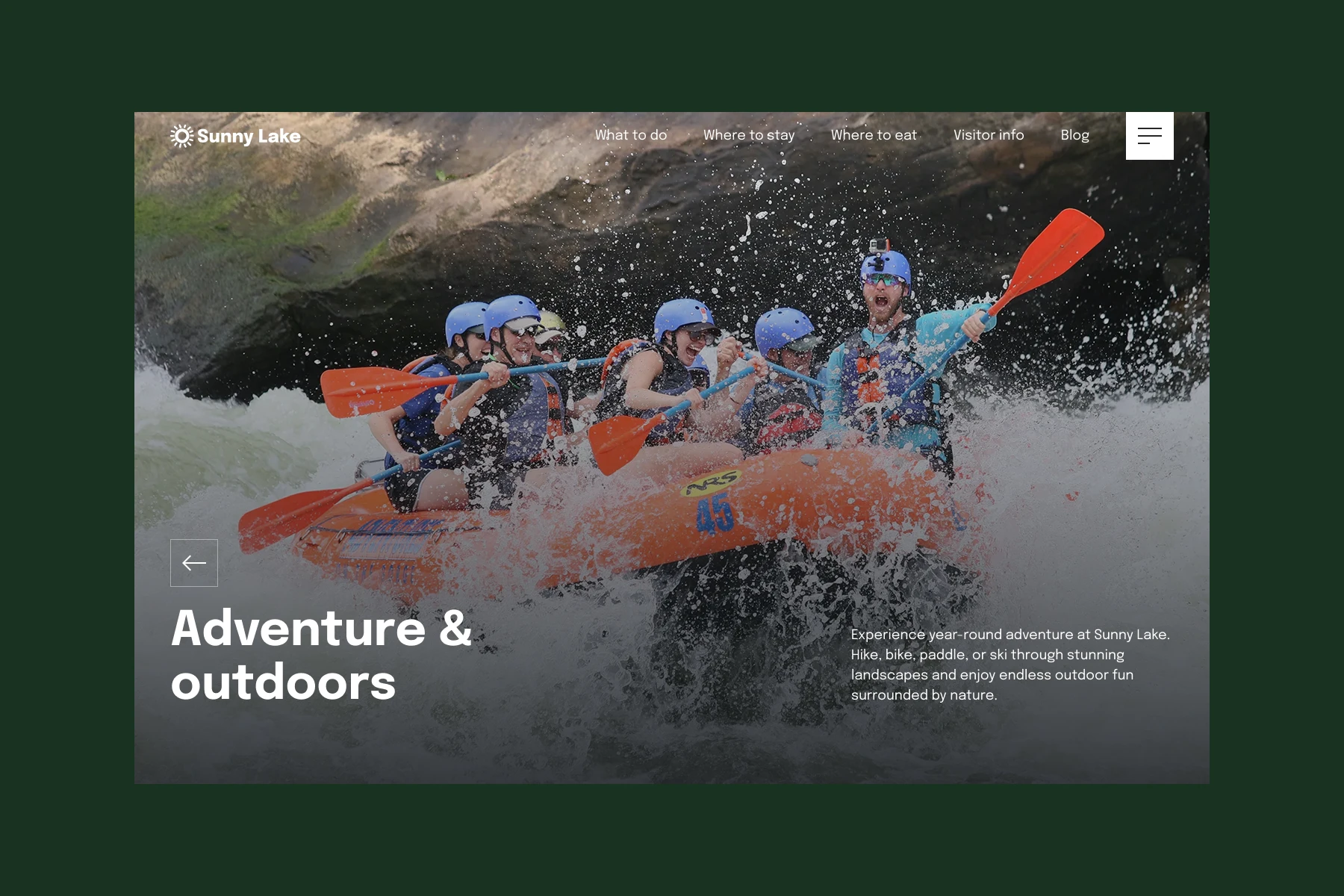 Group of people wearing helmets and life jackets rafting energetically through whitewater rapids.