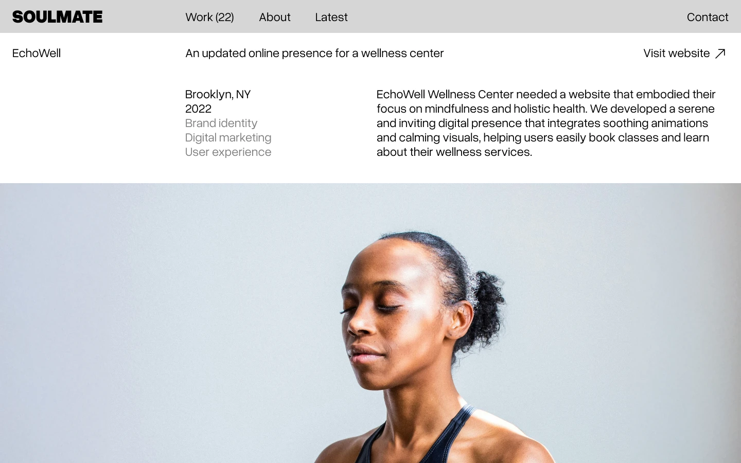 Calm woman meditating with eyes closed against a light gray background below website header.