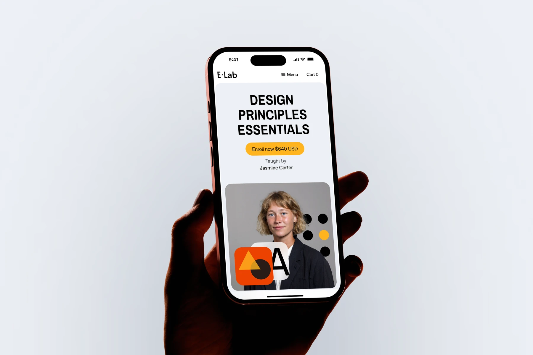 Hand holding a smartphone displaying an online course titled 'Design Principles Essentials' taught by Jasmine Carter with an enroll button.