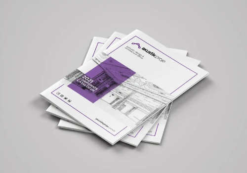 Stack of white brochures with purple accents and architectural drawings on the cover.