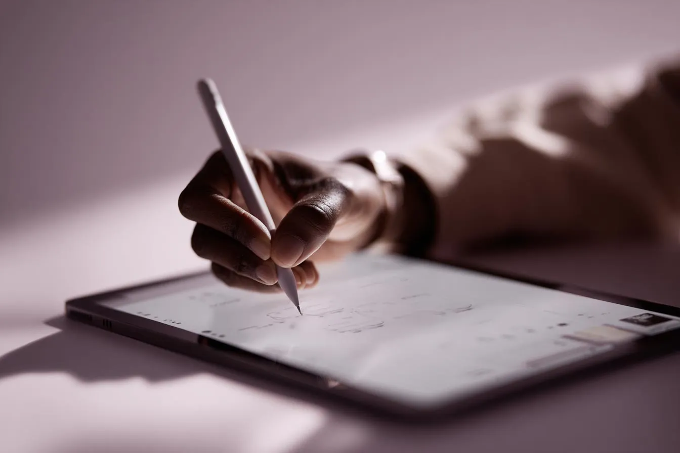 Hand on a tablet writing a brief for packaging for Alex Mileva