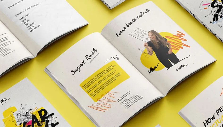 Open book on yellow surface showing a page with the title 'Sugar Rush' and another with a smiling woman and the text 'Focus beats talent.'