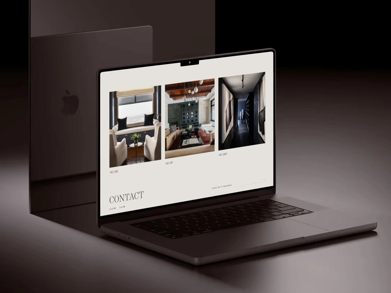 Open laptop displaying a website with interior design photos and a contact section on a white background.