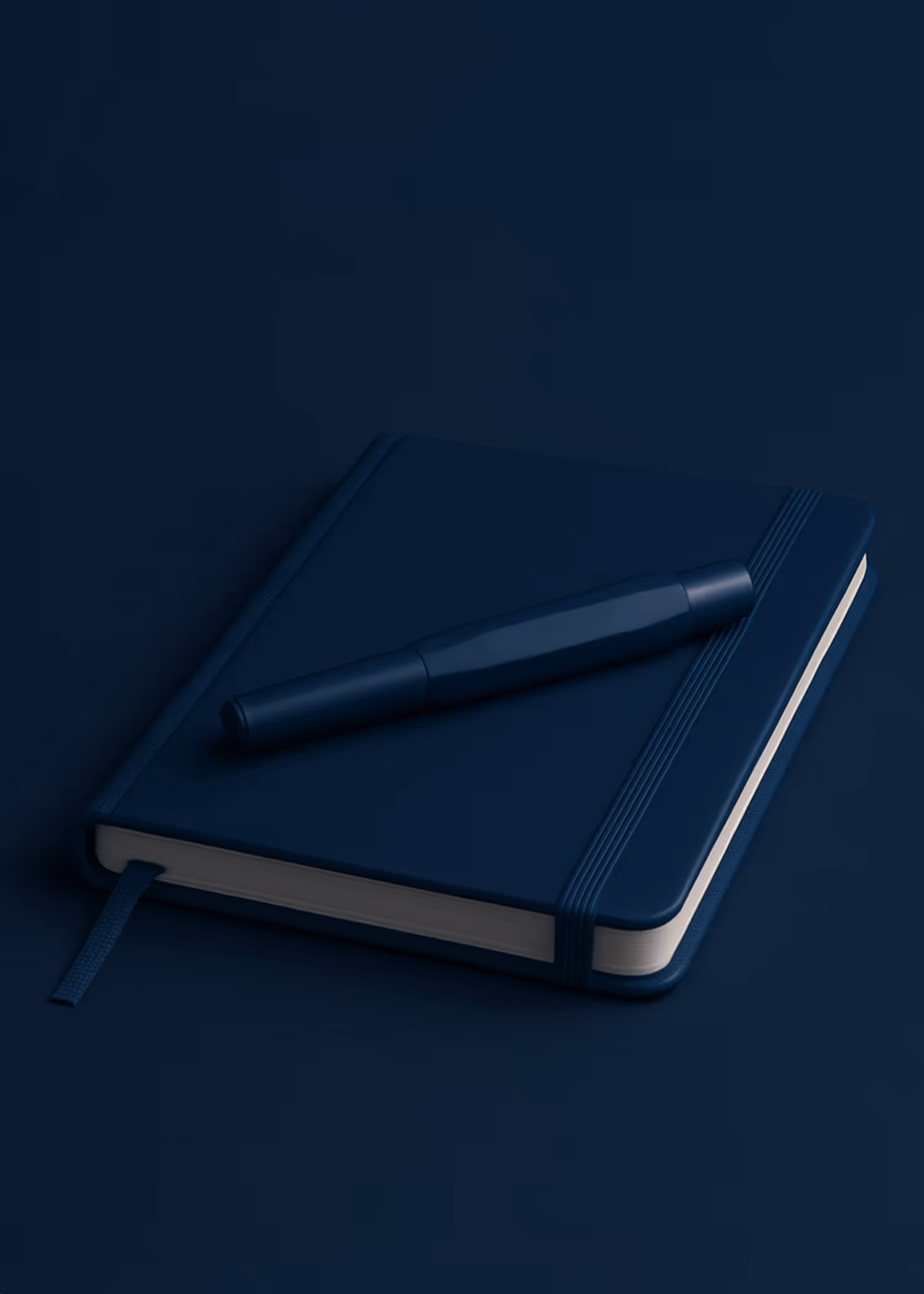 A navy notebook with a pen laying on top of it.