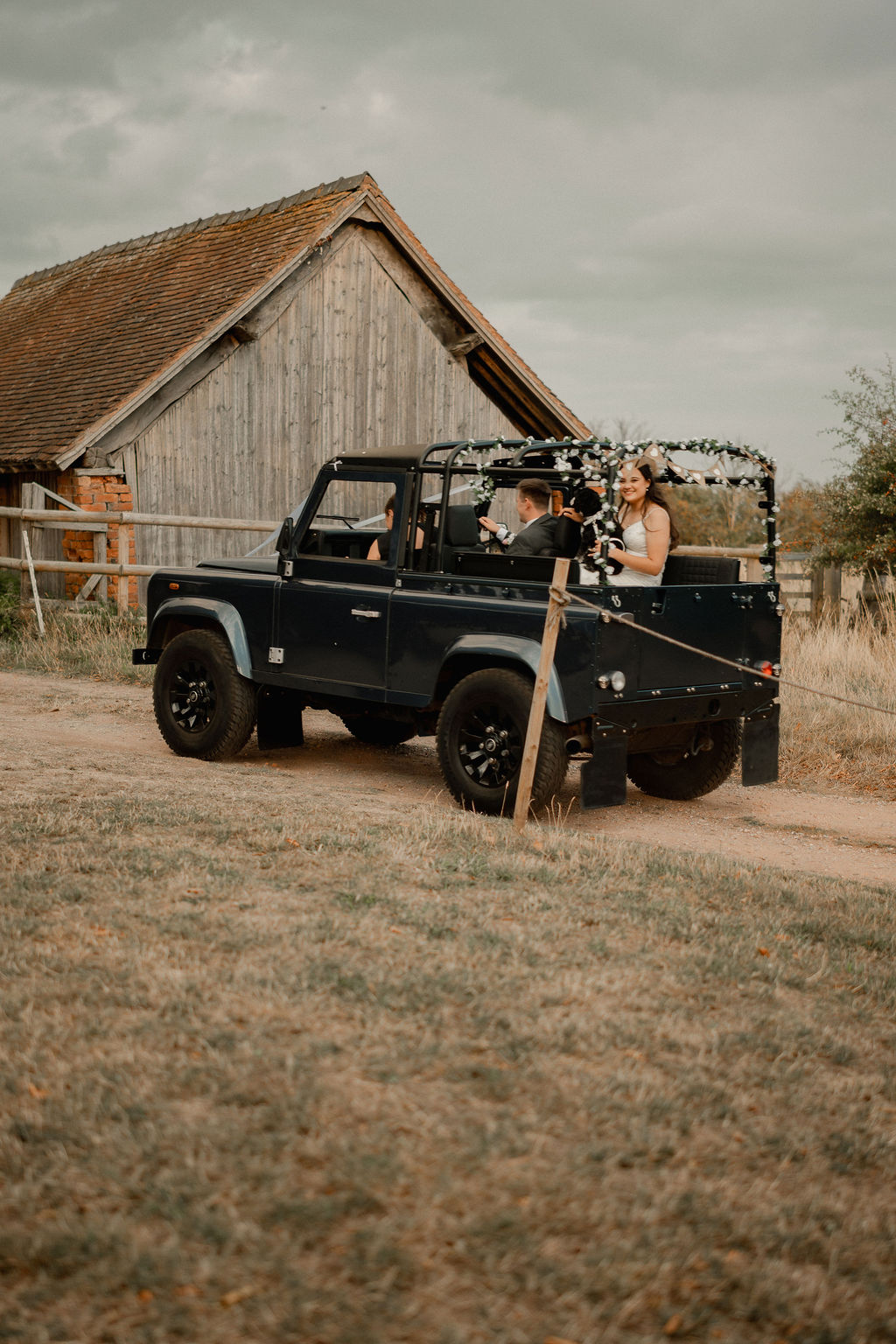 Couple arriving to their South Yorkshire wedding in a blue wedding Land Rover