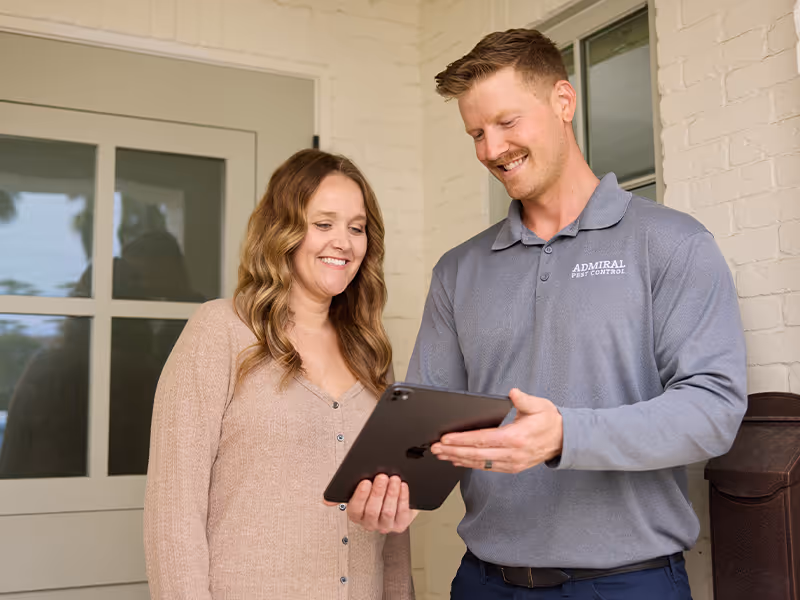rodent control technician reviewing inspection results with a customer