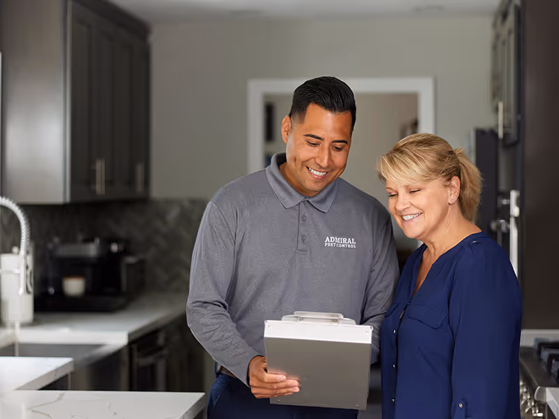 admiral rodent technician reviewing treatment plan with customer