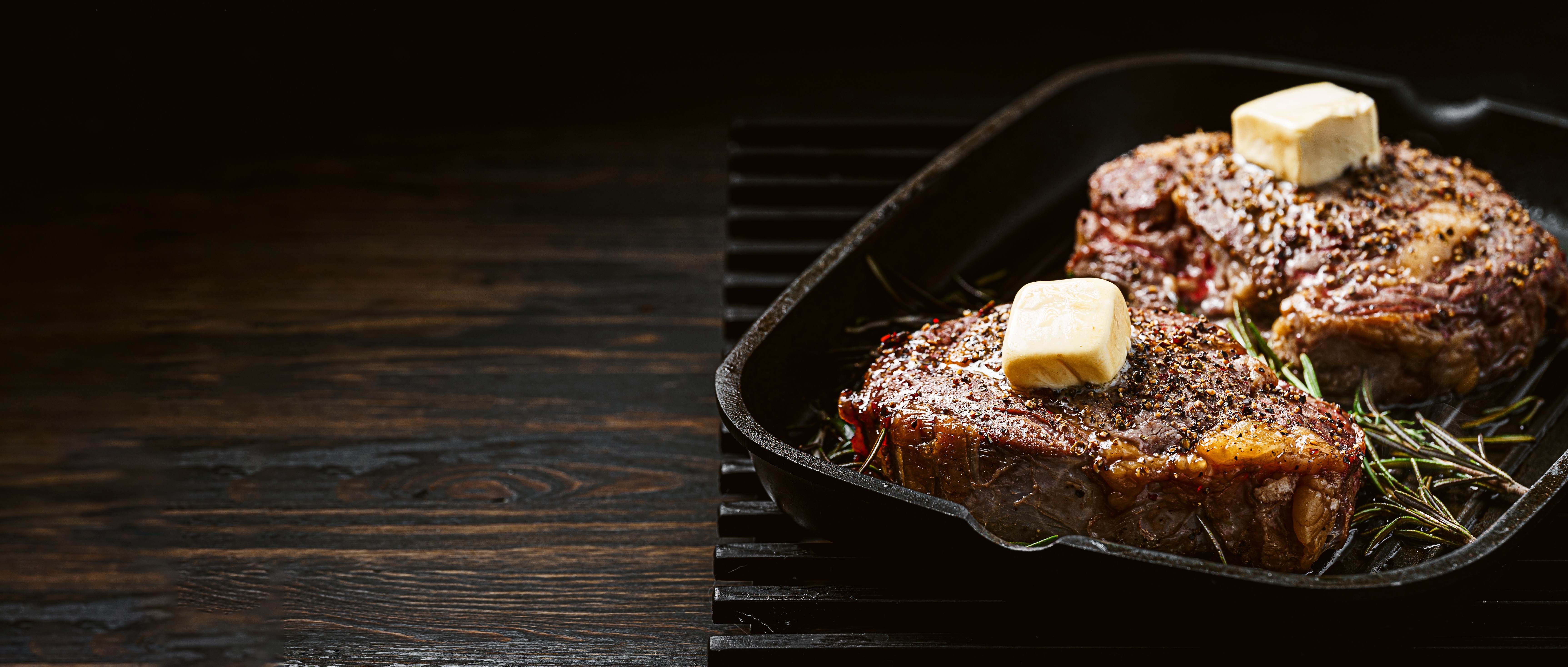 Steak with butter and herbs on cast iron stock image