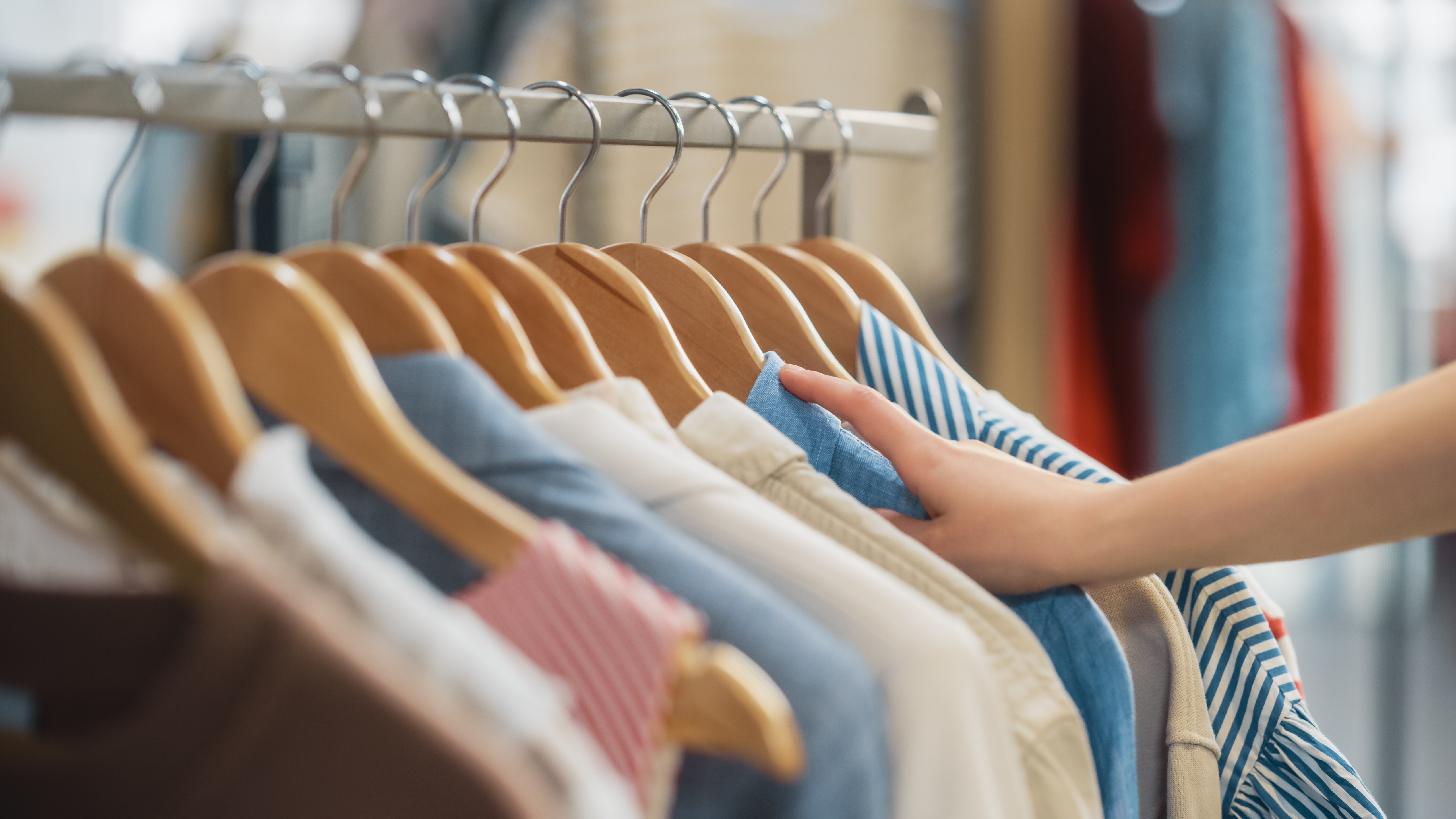 Clothes on hangers on a clothing rack stock image