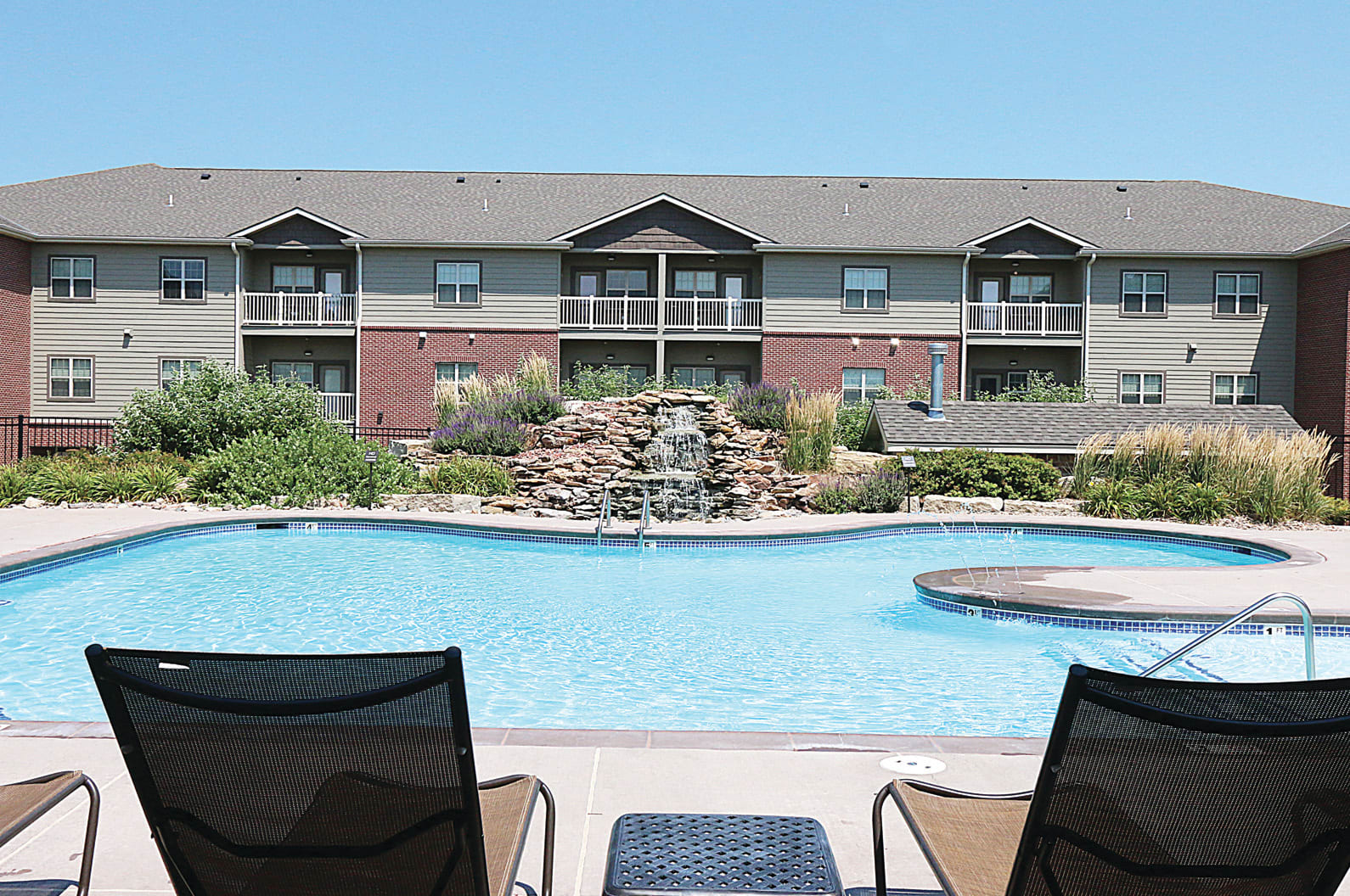 Pools with outdoor seating facing the apartments