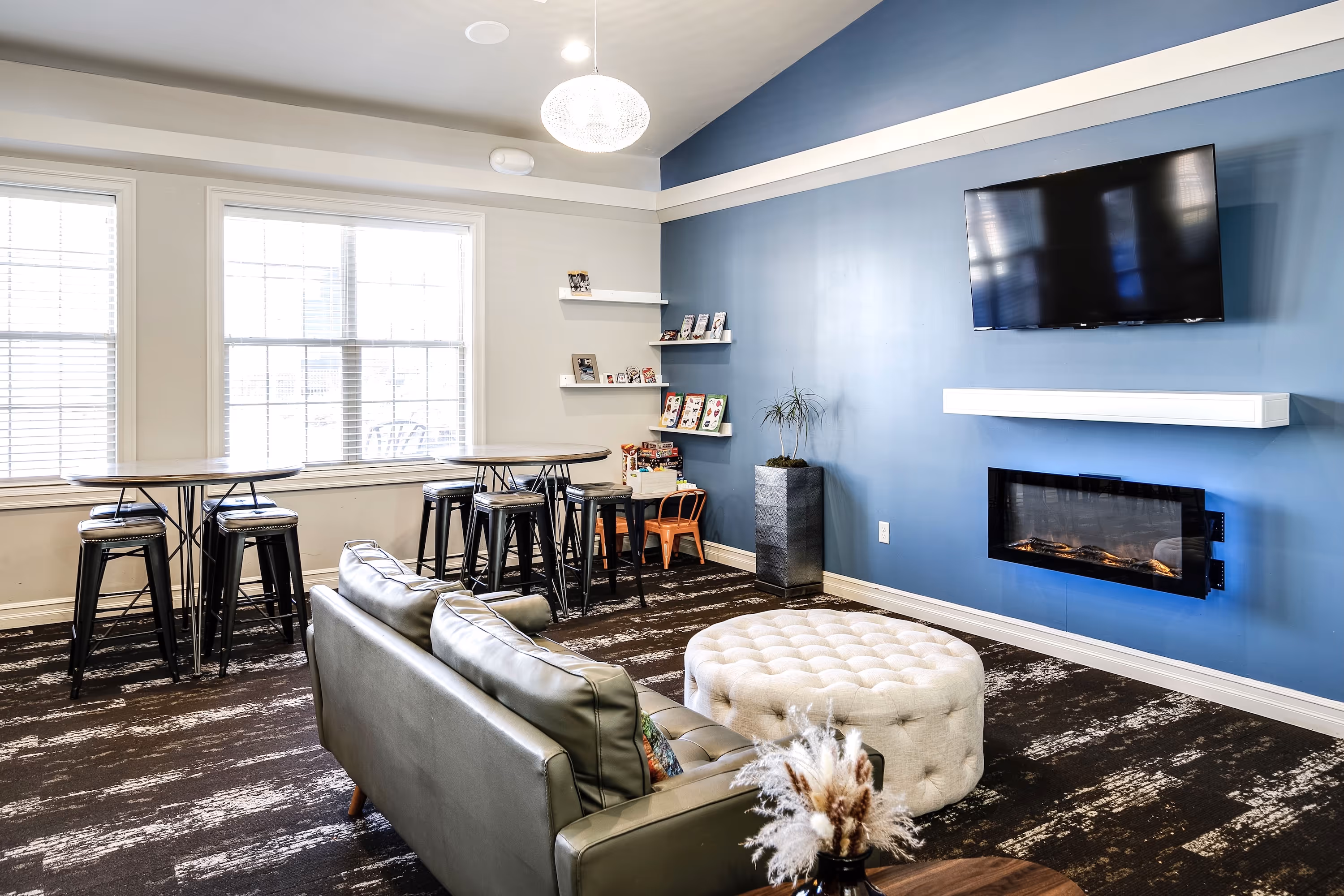 Interior of clubhouse with comfort seating and fireplace with tv mounter