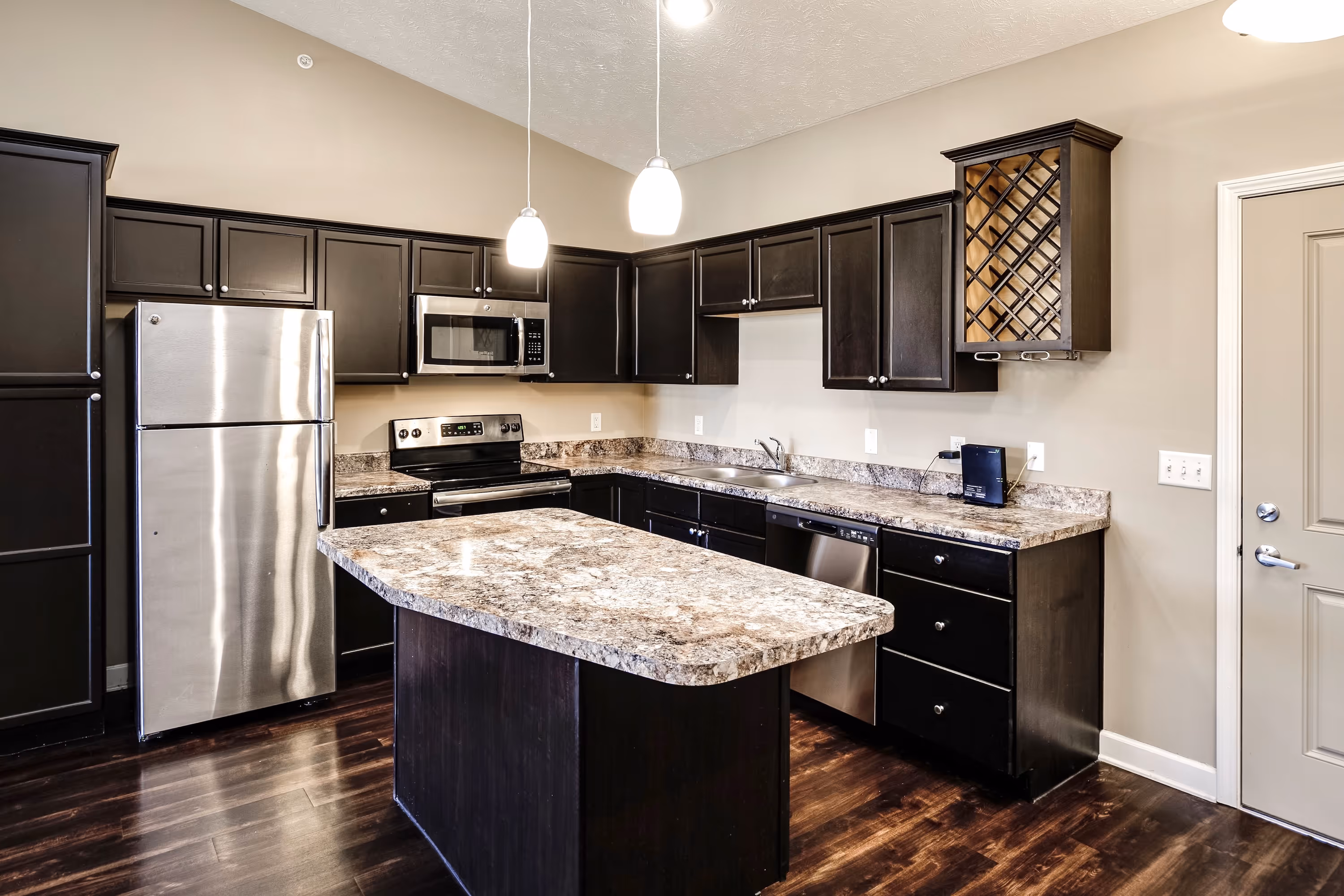 Kitchen with stainless steel appliances and brown cabinetry