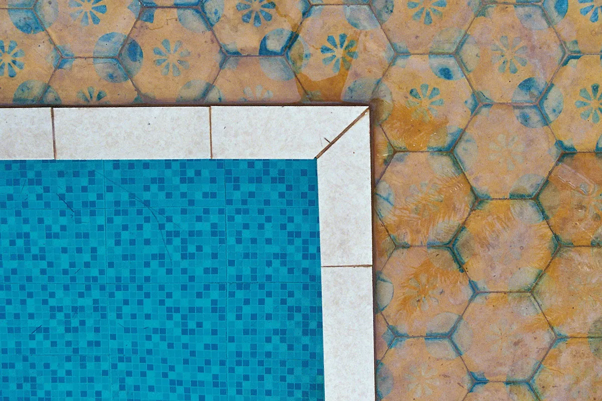 A corner of a pool showing moroccan tiles.
