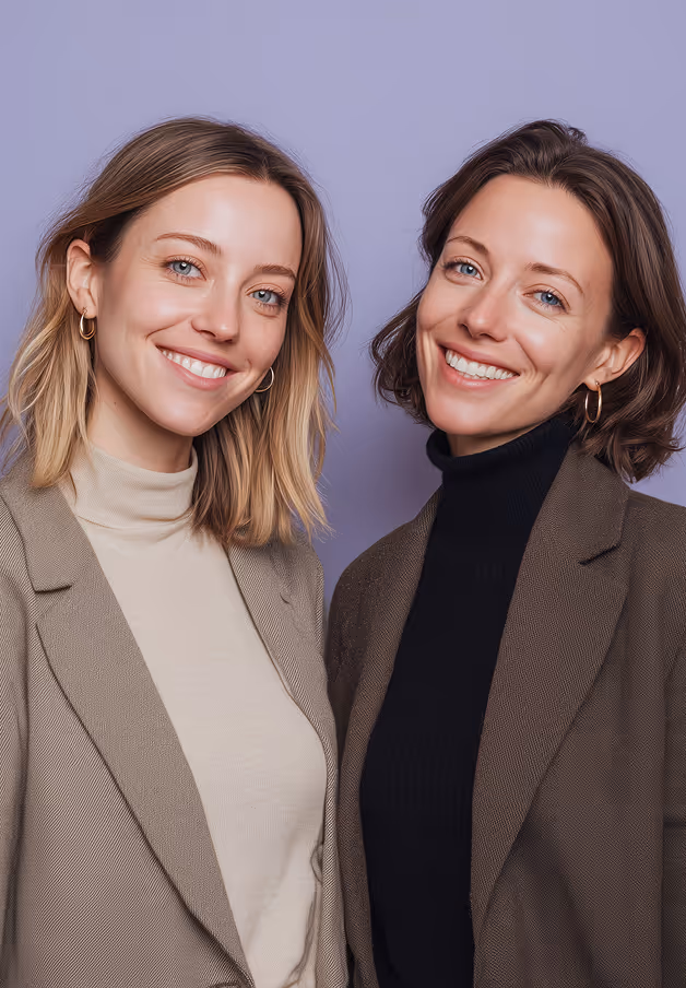 Two professionally dressed women standing together, representing leadership and collaboration in modern recruitment.
