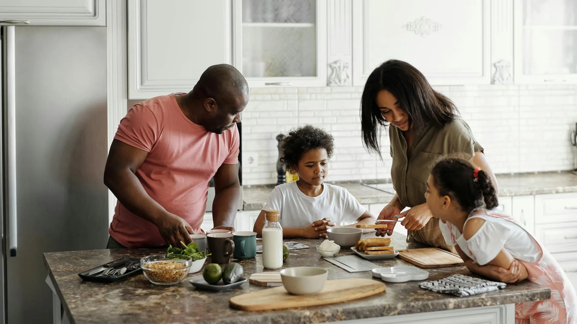 Family enjoying making dinner together. Bail bonds in Covington, LA make freedom accessible for families.