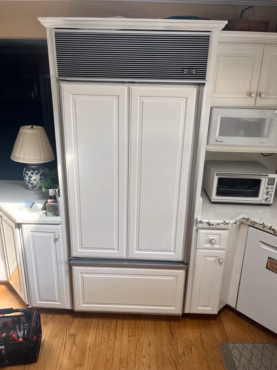 Panel-ready Sub-Zero built-in refrigerator with custom cabinet doors