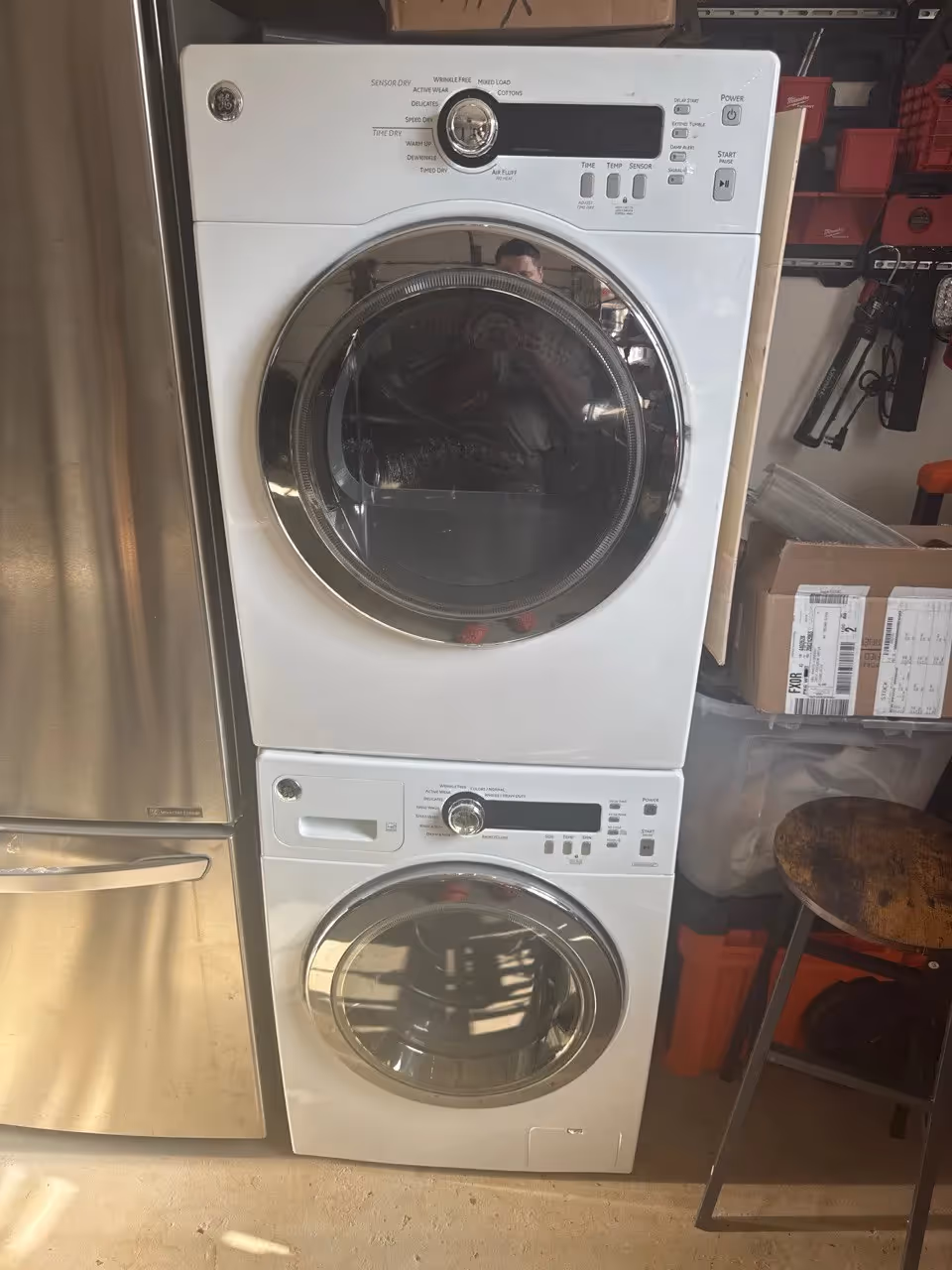 White GE front-load washer and dryer stacked together