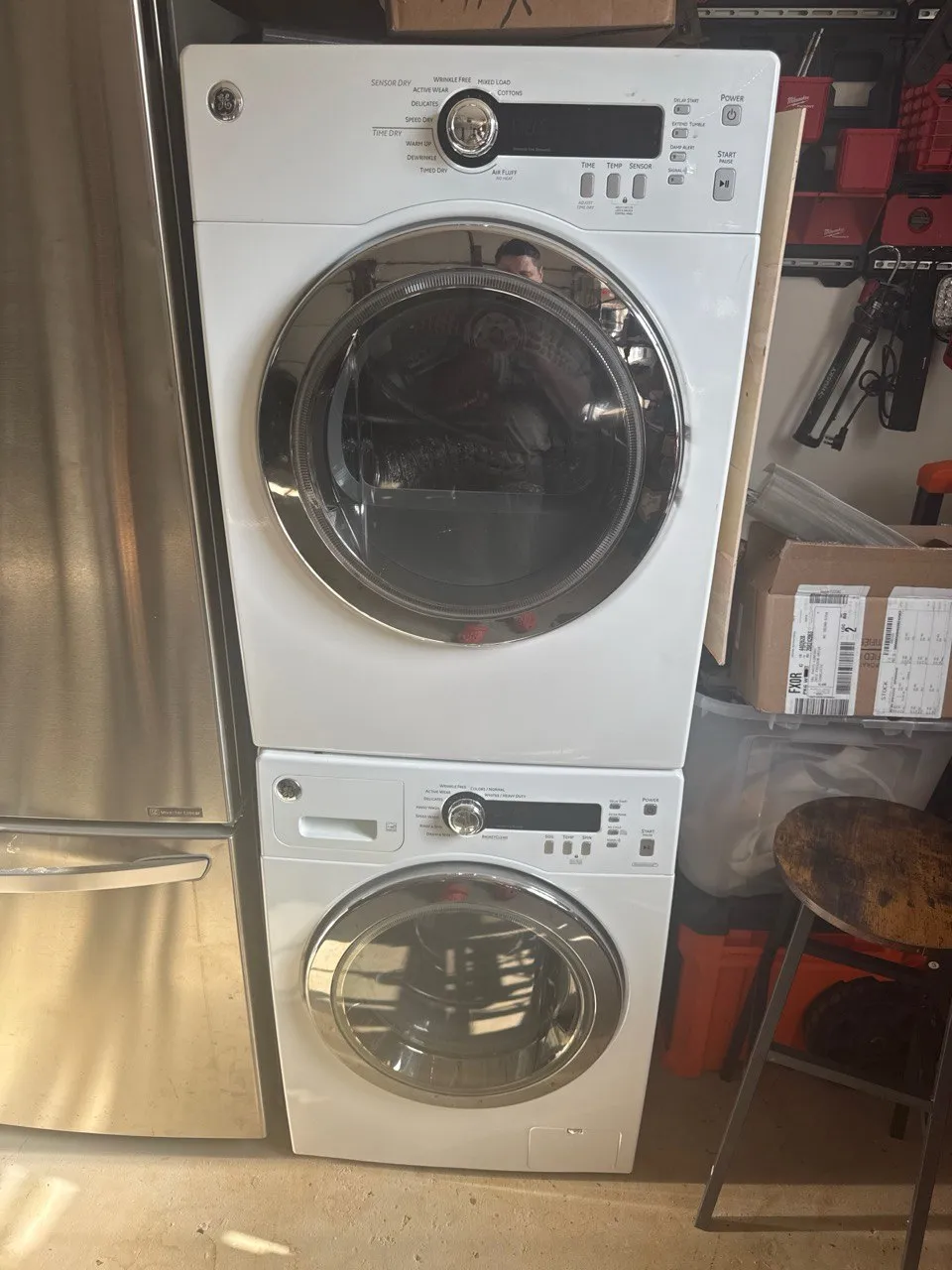 White GE front-load washer and dryer stacked together