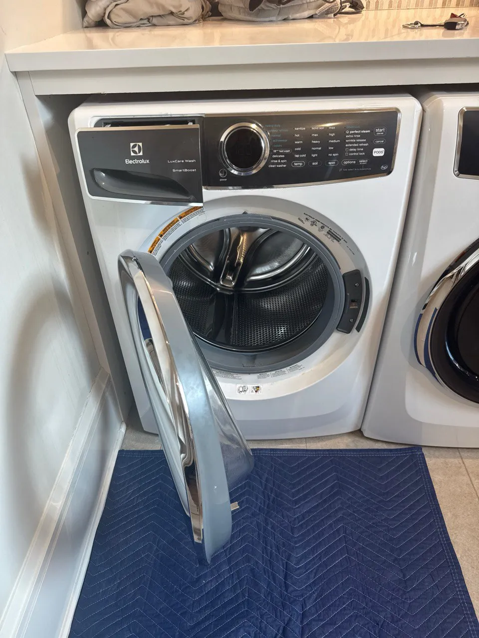 Electrolux front-load washer undergoing repair with the door removed.