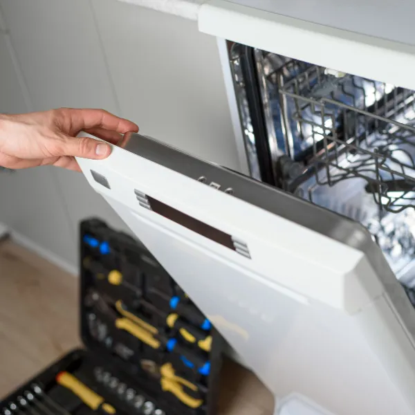 technician opening dishwasher to inspect