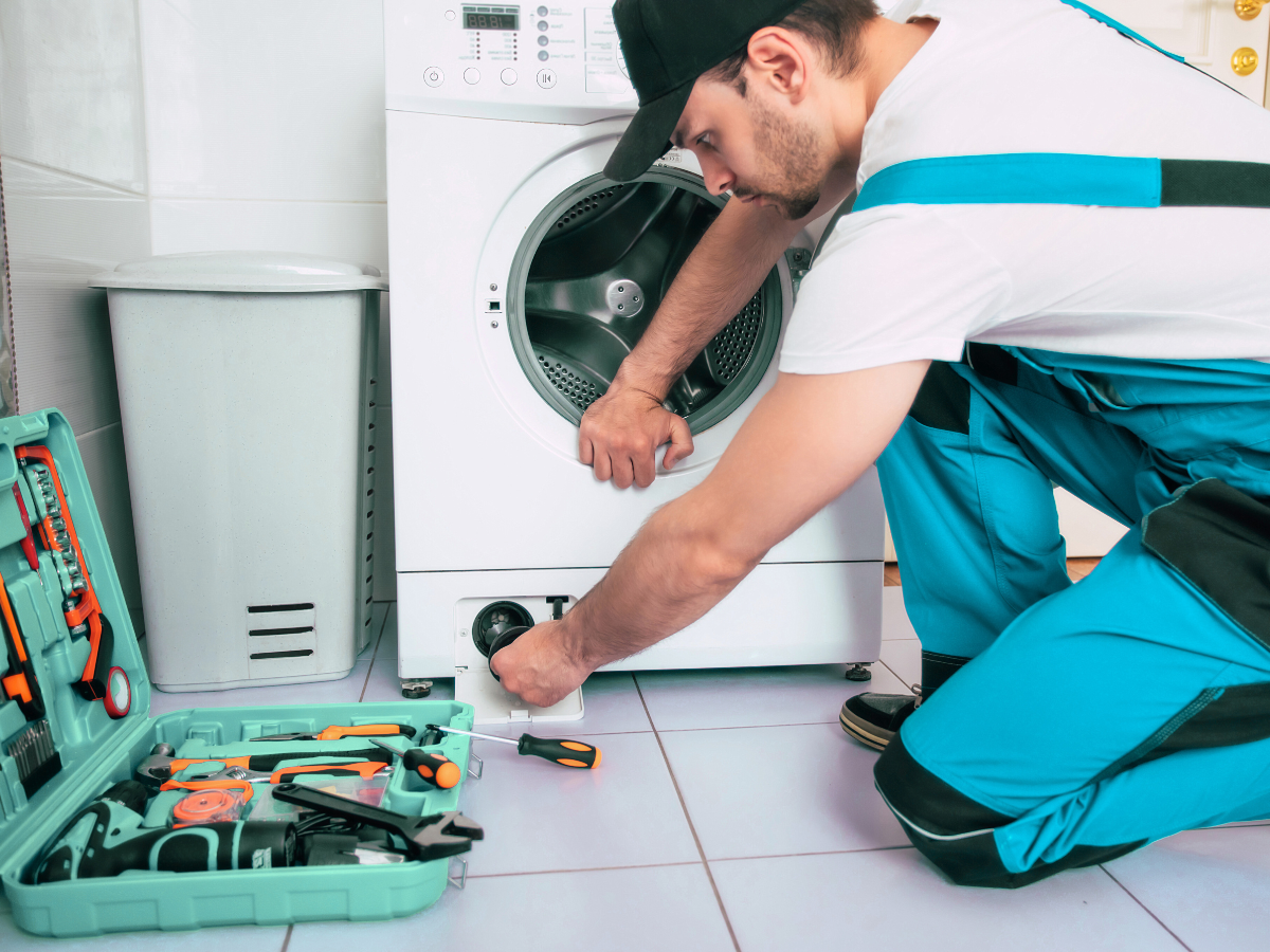 technician repairing a washer