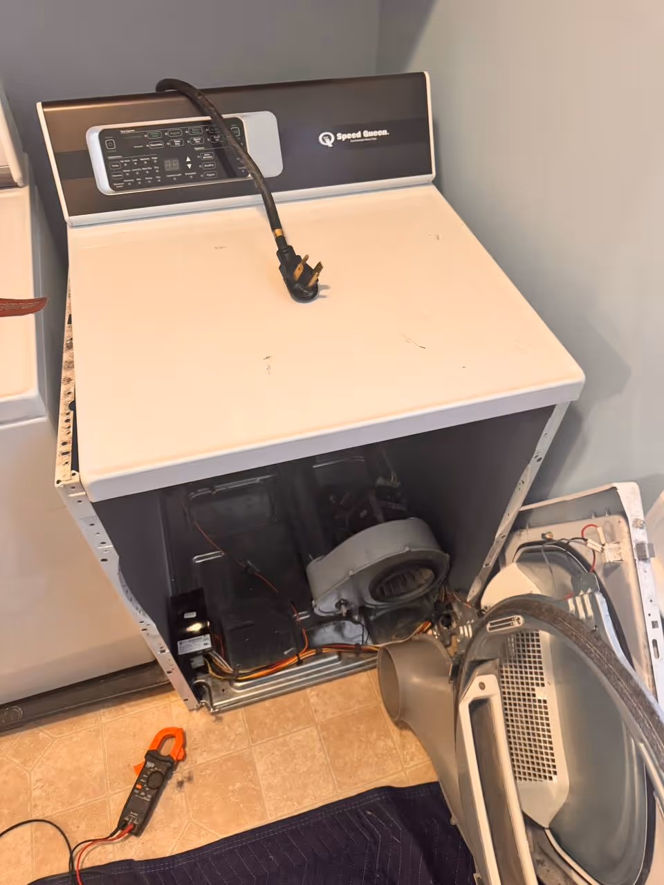 Speed Queen dryer repair with front panel removed during diagnostic inspection