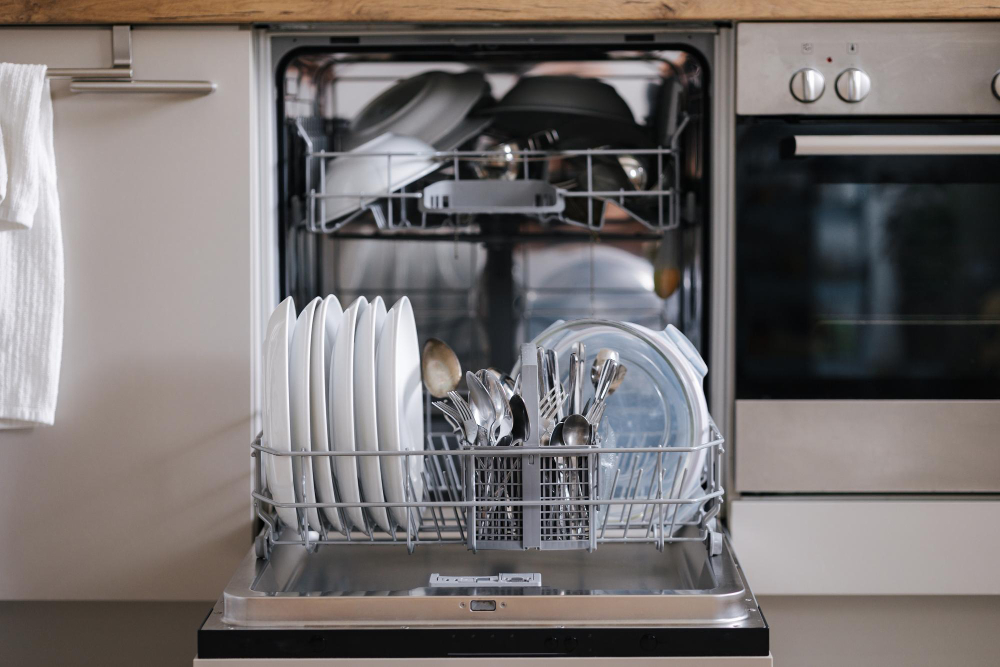 Open dishwasher loaded with clean dishes after professional repair service