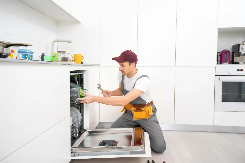 appliance technician repairing dishwasher