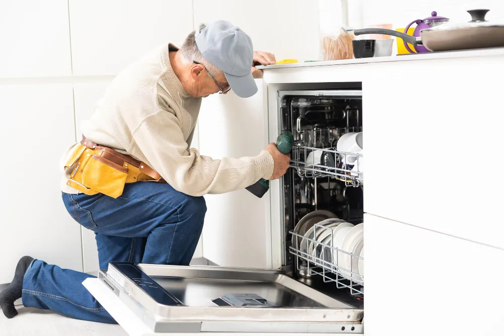 technician inspecting dishwasher