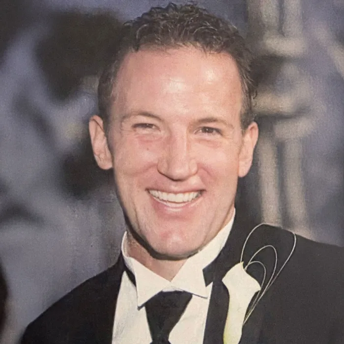 Vetabolics founder Rick Galyean – Smiling man in a tuxedo with a white calla lily boutonniere.