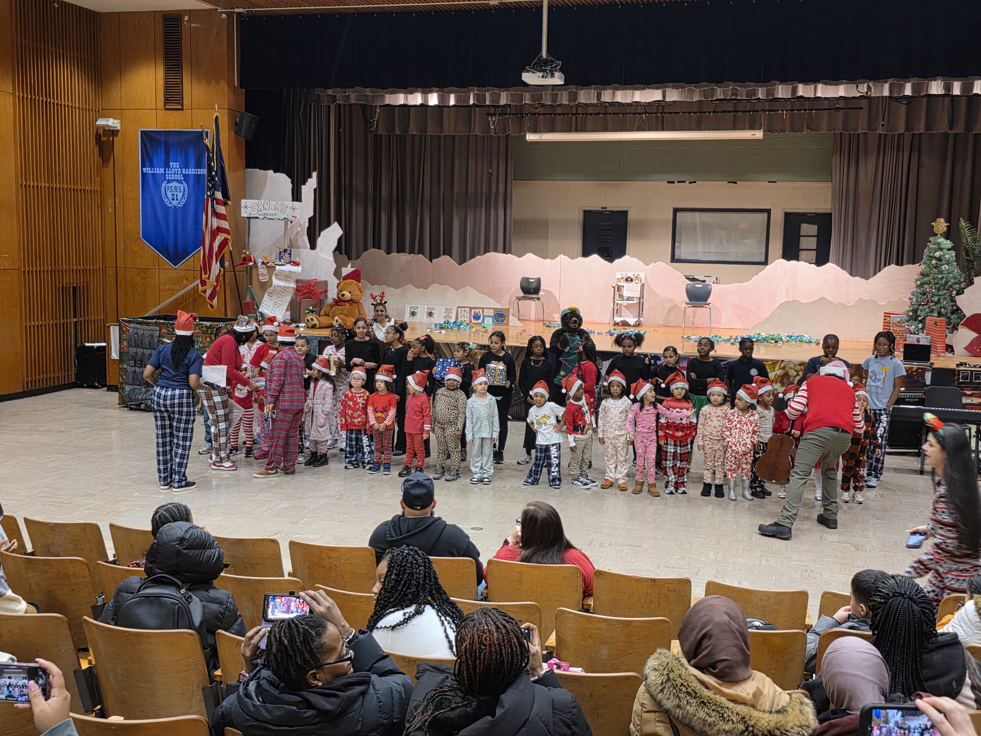 Students in holiday pajamas performing at school Christmas concert