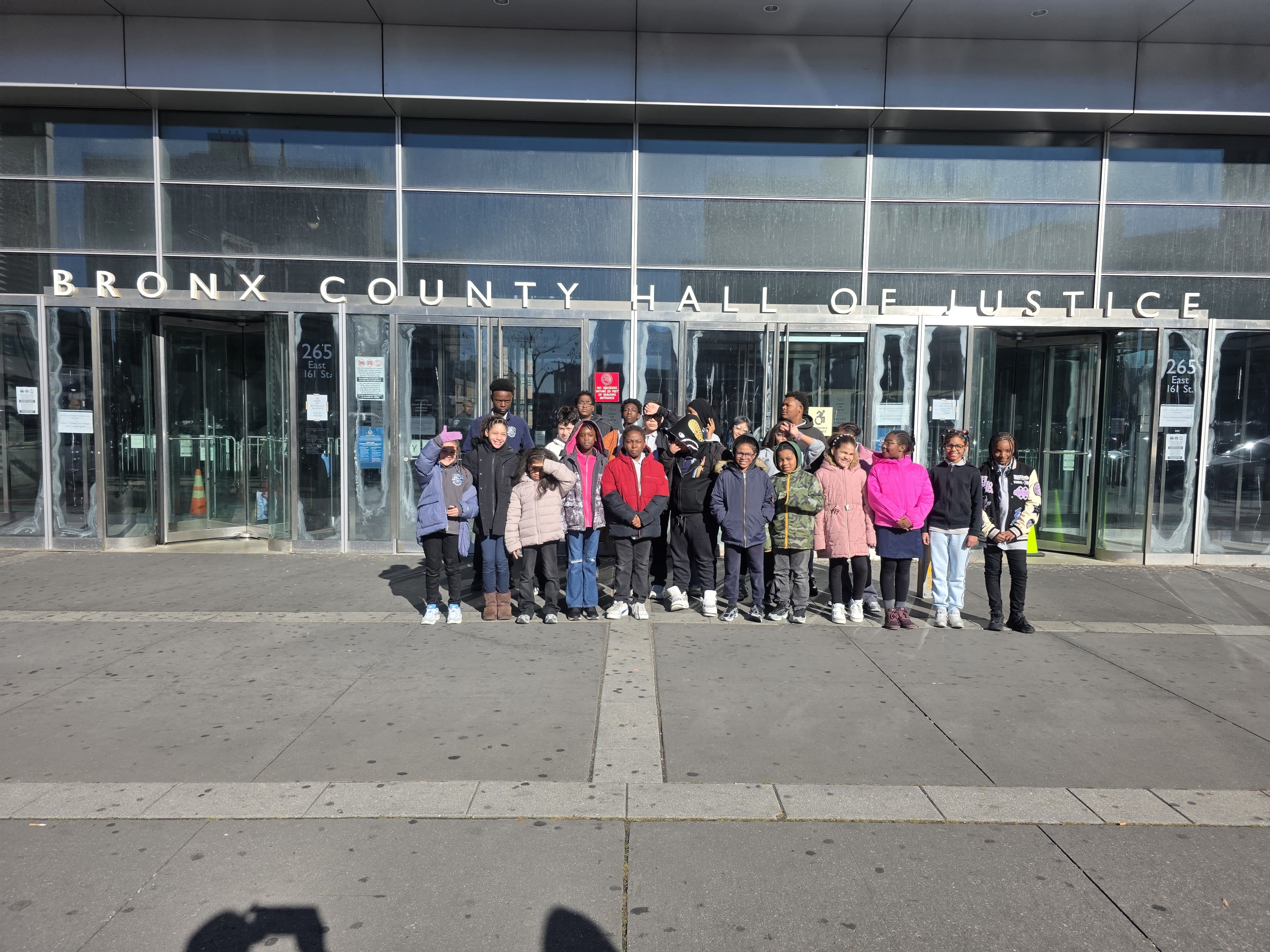 Students pose outside Bronx County Hall of Justice on field trip
