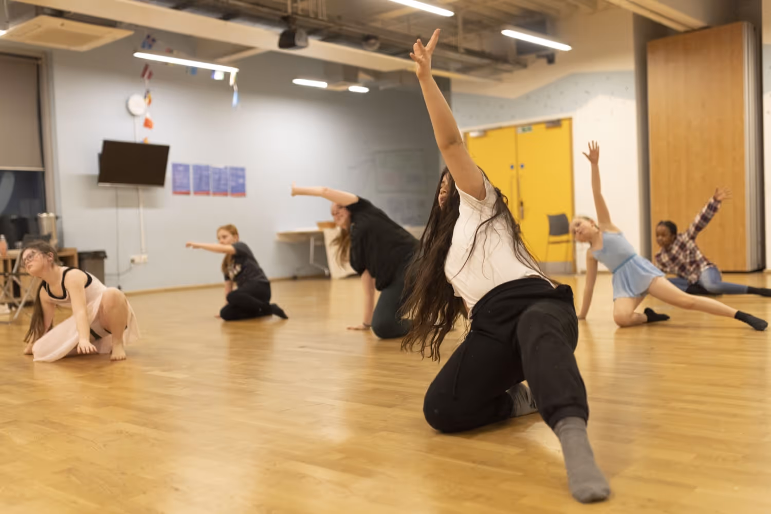 A group of young people in a performing arts class.