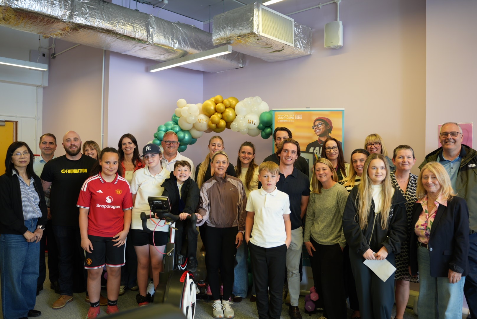 Manchester Youth Zone - People stood in room with exercise bike