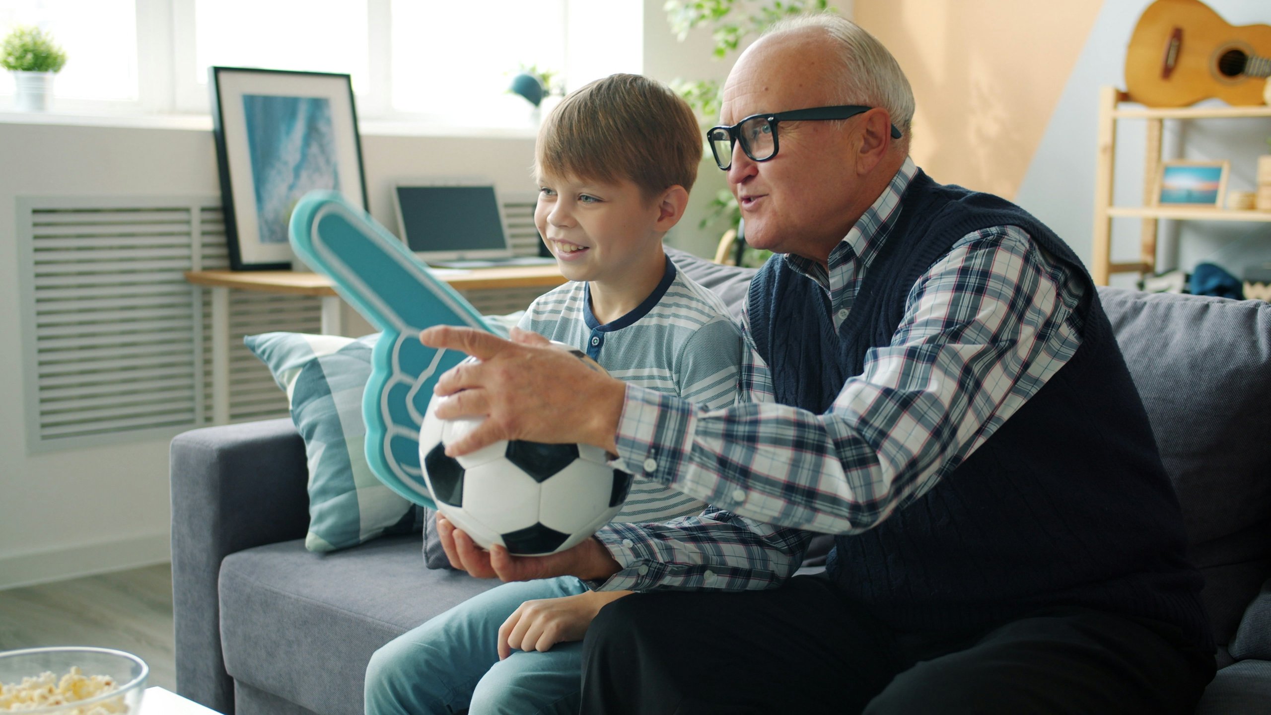 Son and grandfather watching sports