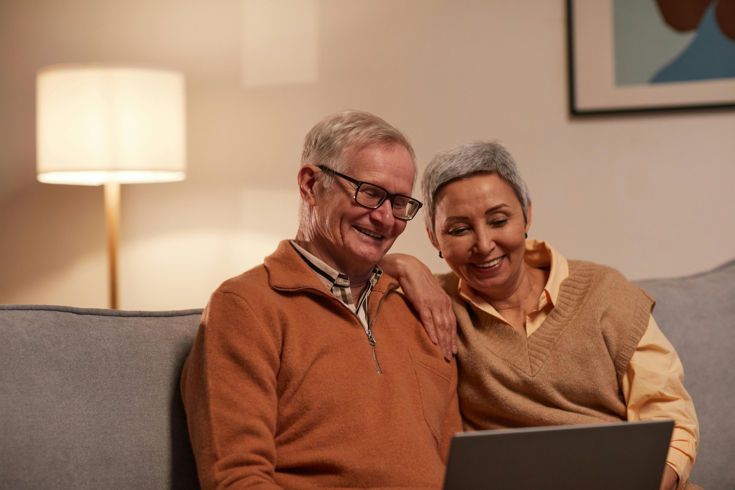 Happy couple looking at their computer
