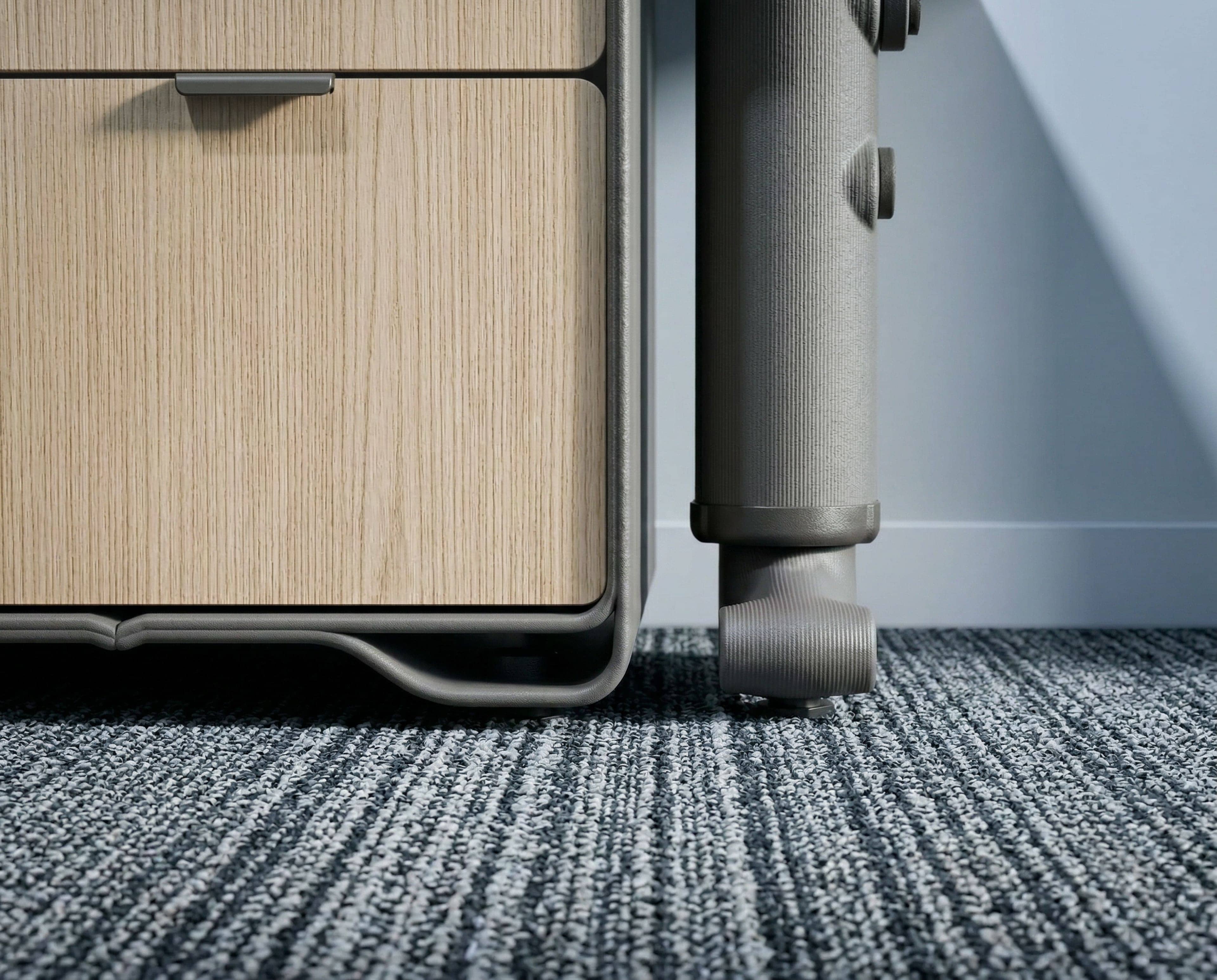 Modern black sculptural chair with angular folds displayed on a round illuminated platform against a textured wall.