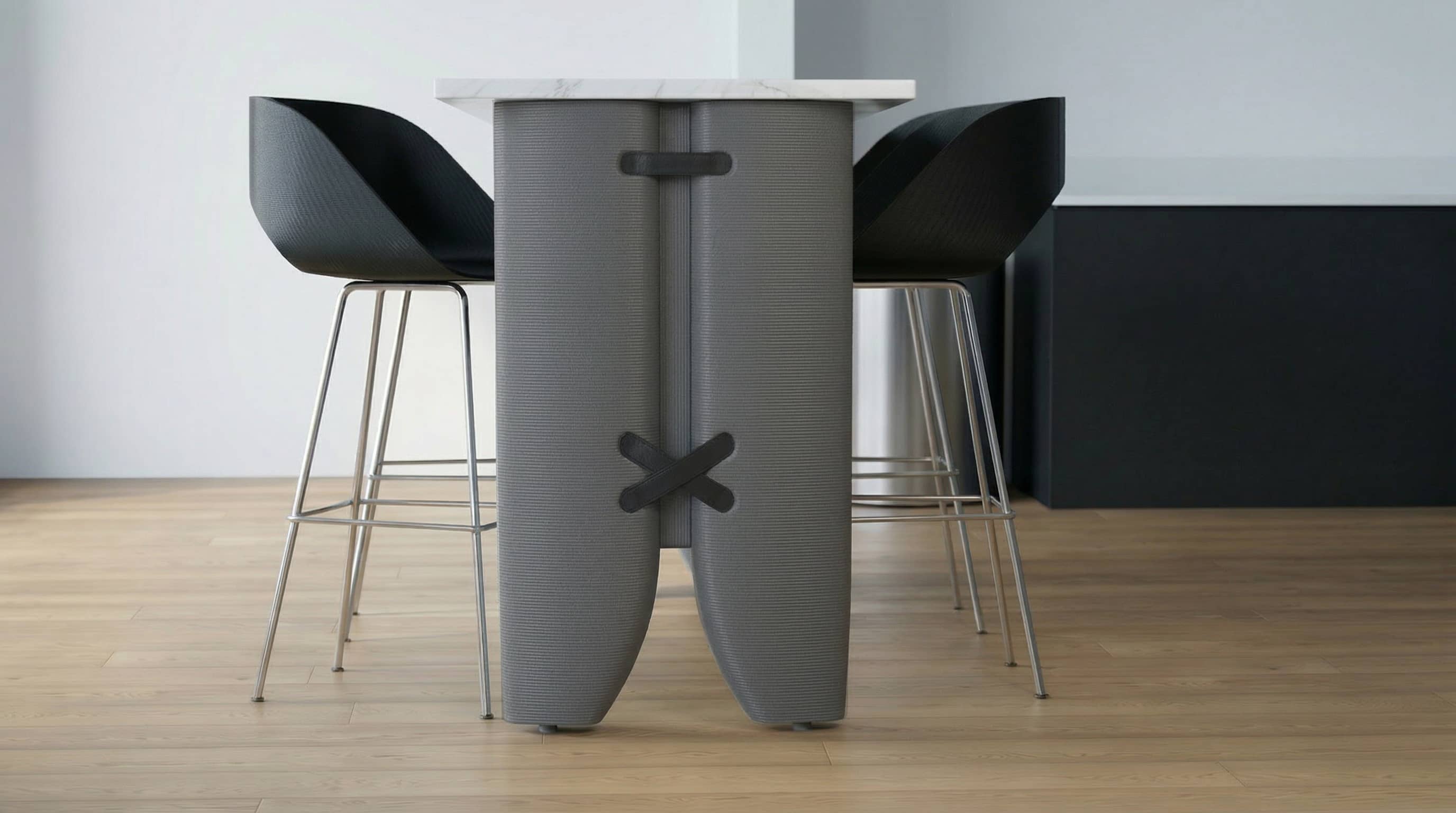 Modern office desk with wood surface, monitor on adjustable arm, black mesh chair, wooden storage cabinets, and a gray upholstered chair near a window.