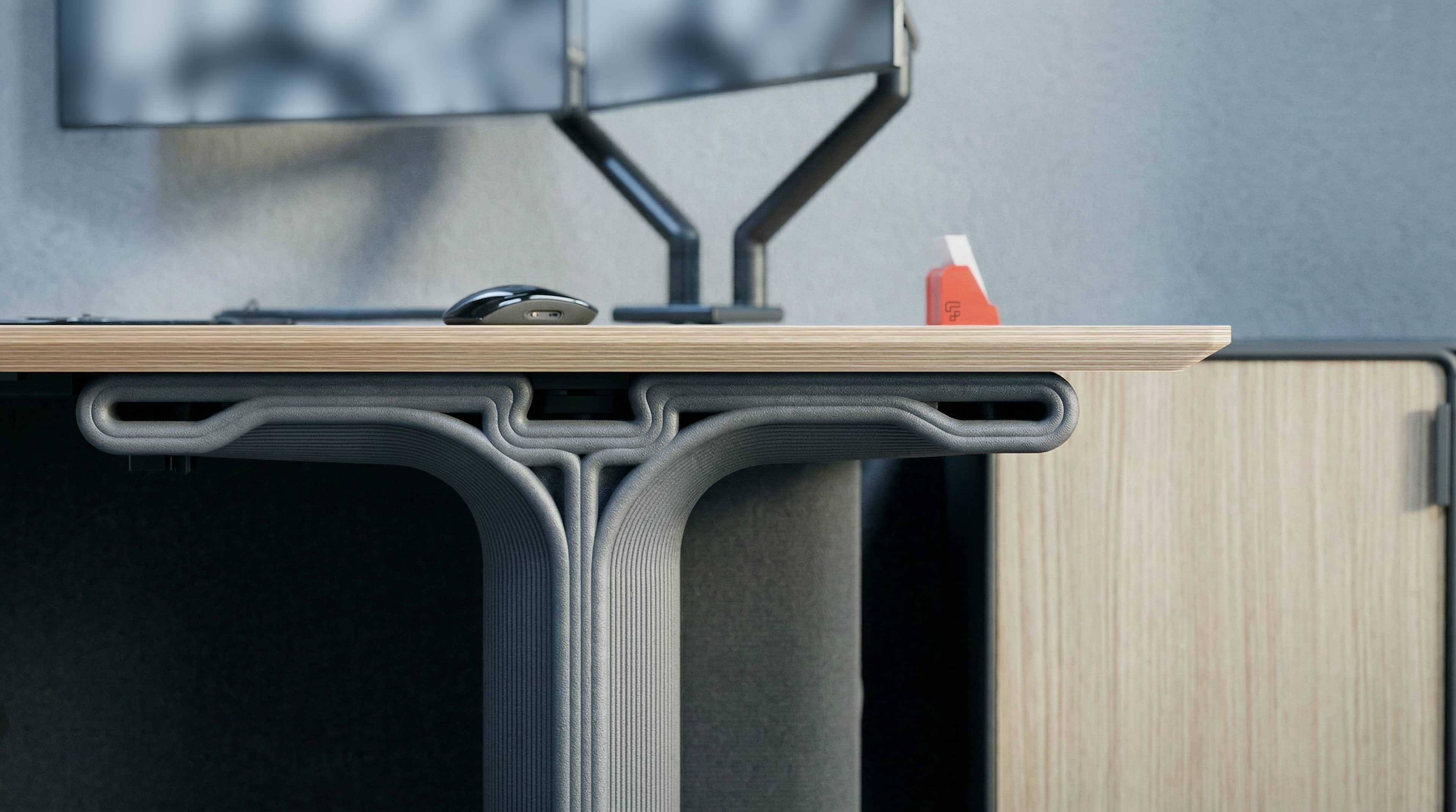 Modern seating area with uniquely shaped metallic and leather chairs and cubes arranged as seats and shelves, with a potted plant and framed artwork in the background.