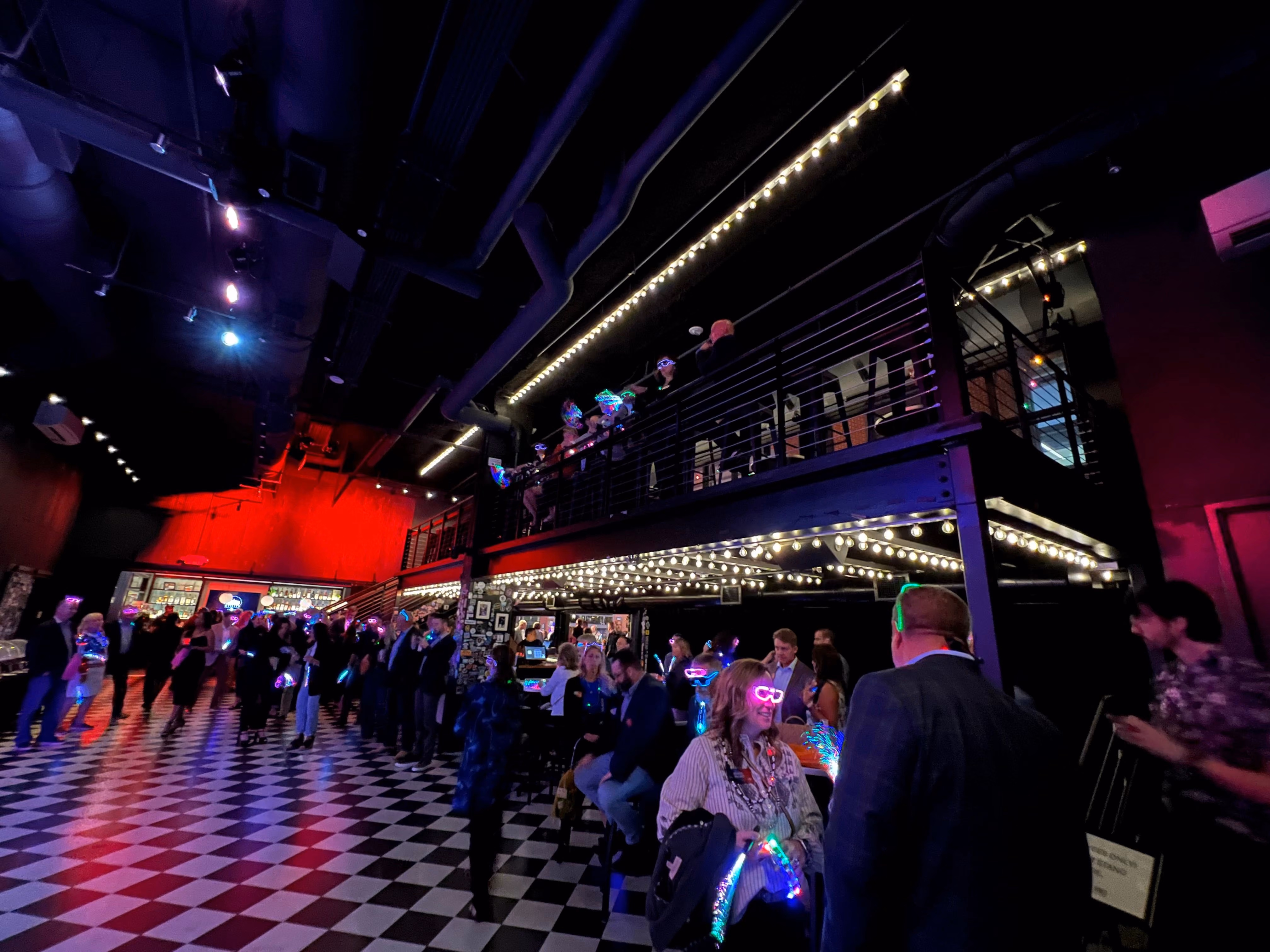 Guests at a private event on the checkered floor of Pearl Street Warehouse